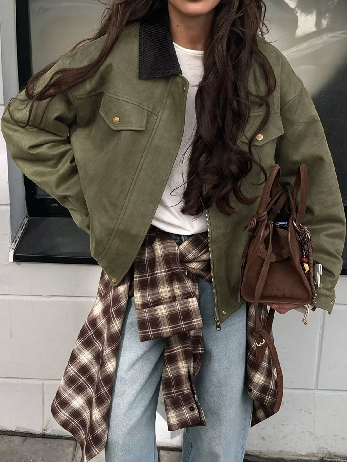 Army-green jacket with a black contrast collar, worn open.