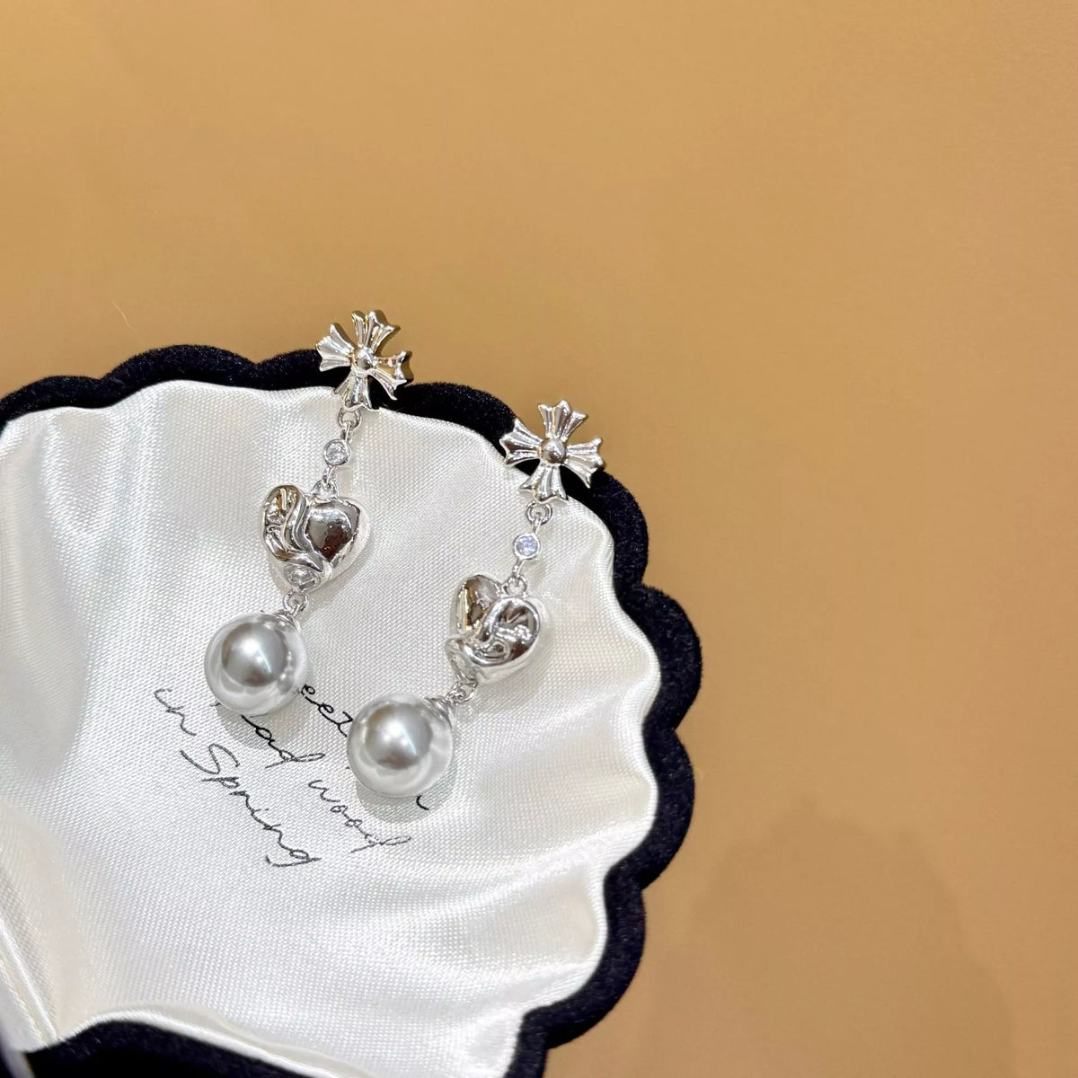 Heart-shaped drop earrings with gray pearl-like beads