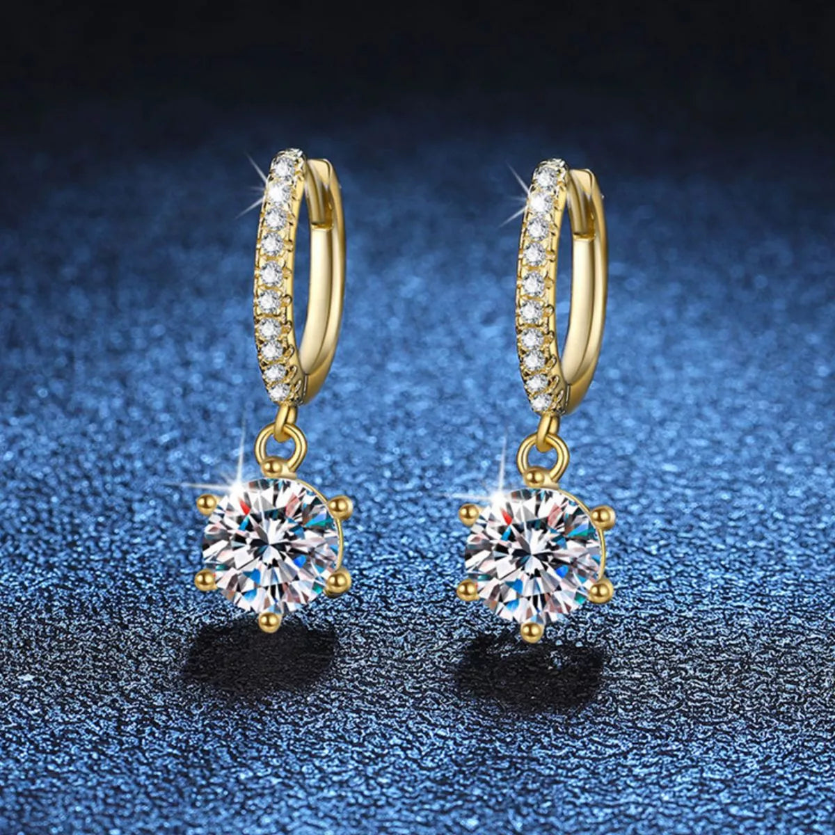 Gold-tone hoop earrings with round clear stone drops — detail view