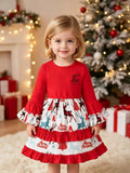 Child wearing a red Christmas dress with reindeer-print skirt panels and ruffled sleeves.