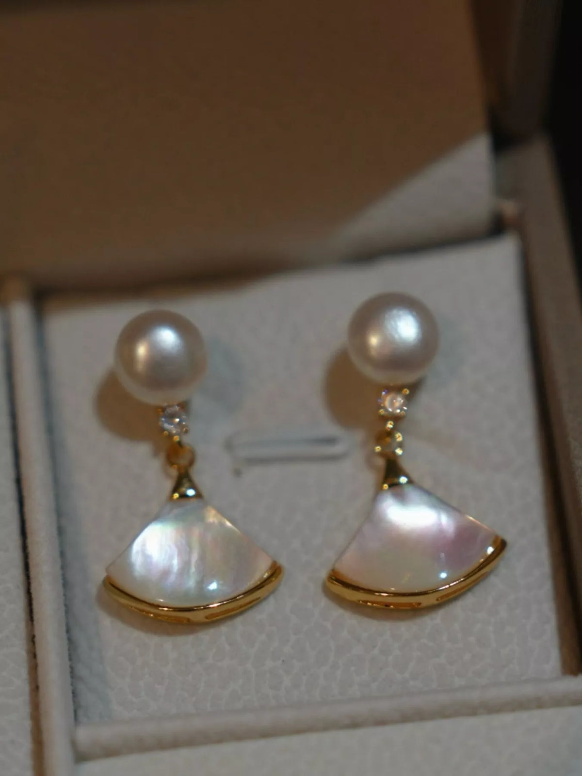 Fan-shaped drop earrings with pearl-like beads and gold-tone edges — detail view