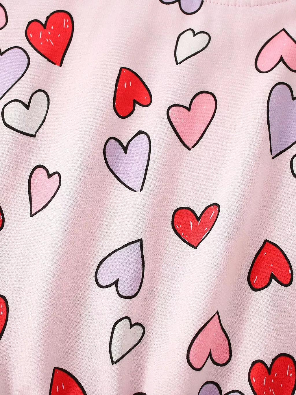 Red and white heart pattern on pink sweatshirt fabric