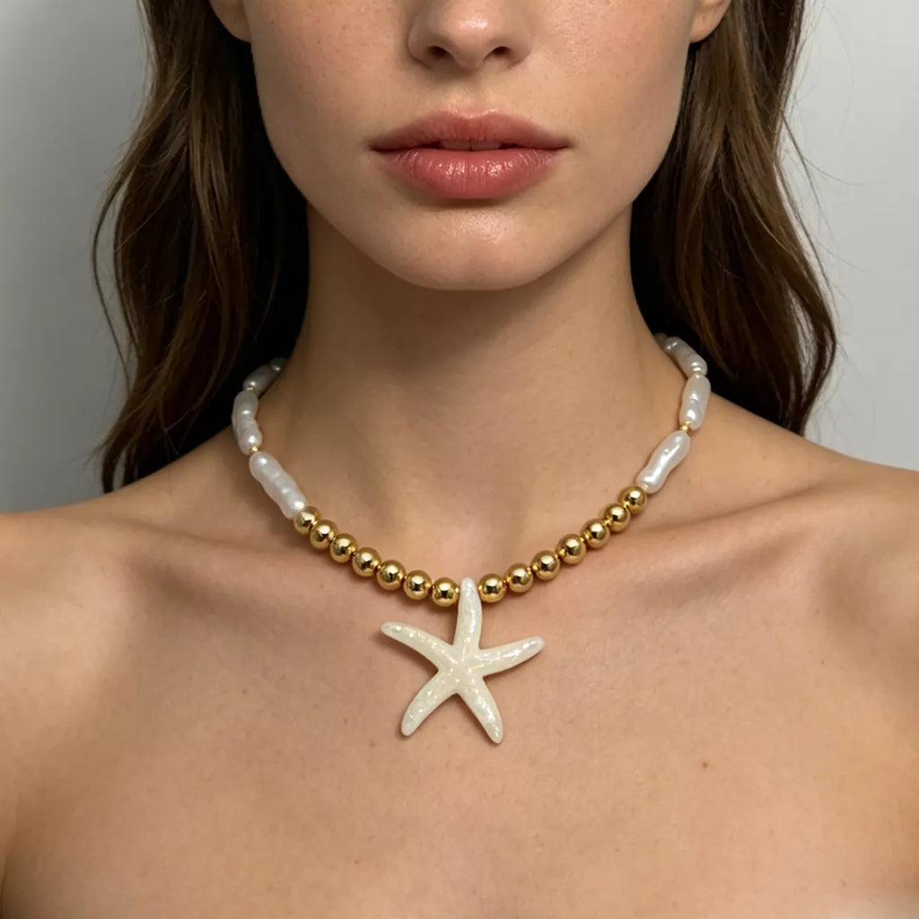 Starfish pendant necklace with gold-tone beads and white shell-like links