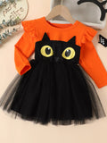 Front view of an orange long-sleeve black-cat dress with yellow eyes and a black tulle skirt.