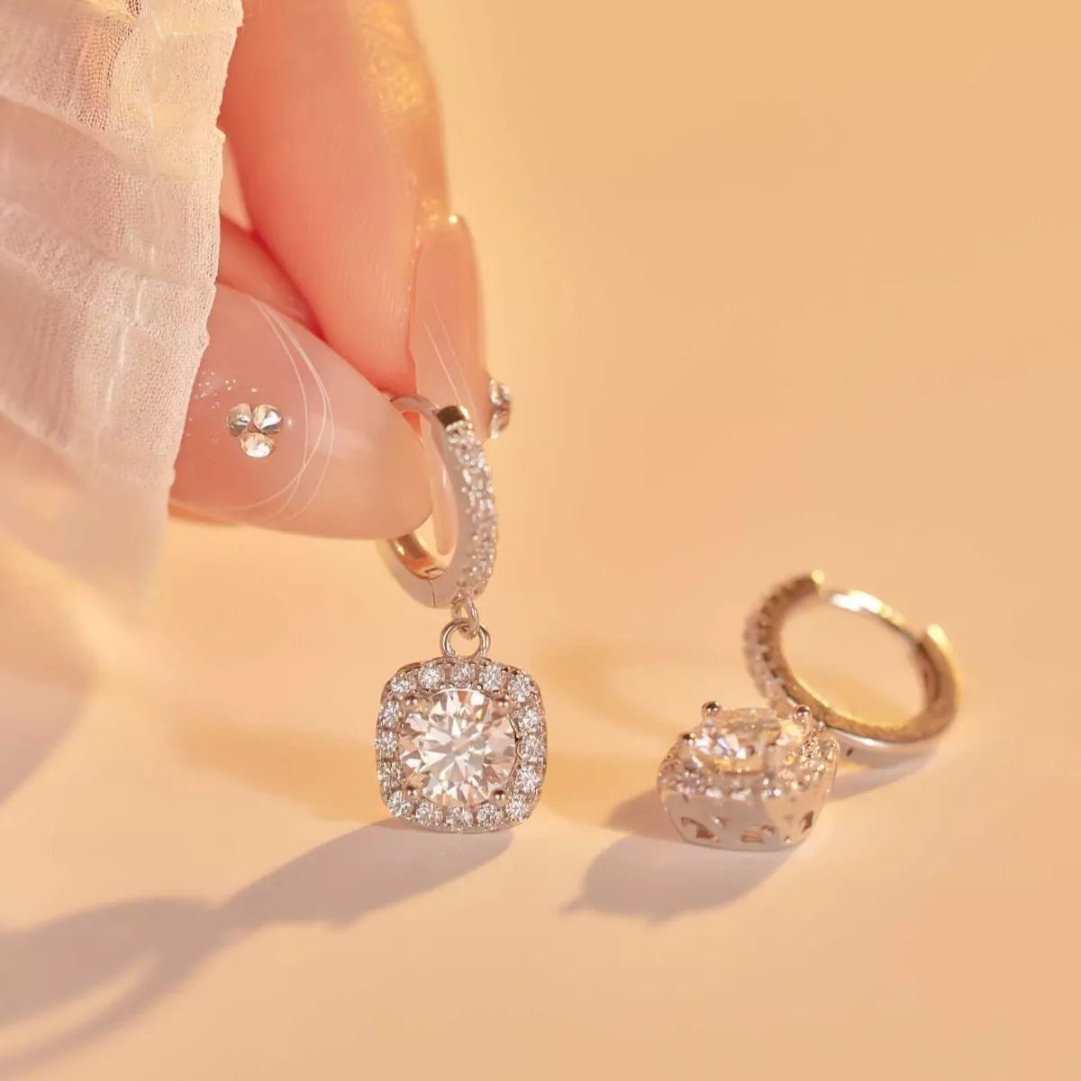 Silver-tone hoop earrings with square halo stone drops — detail view