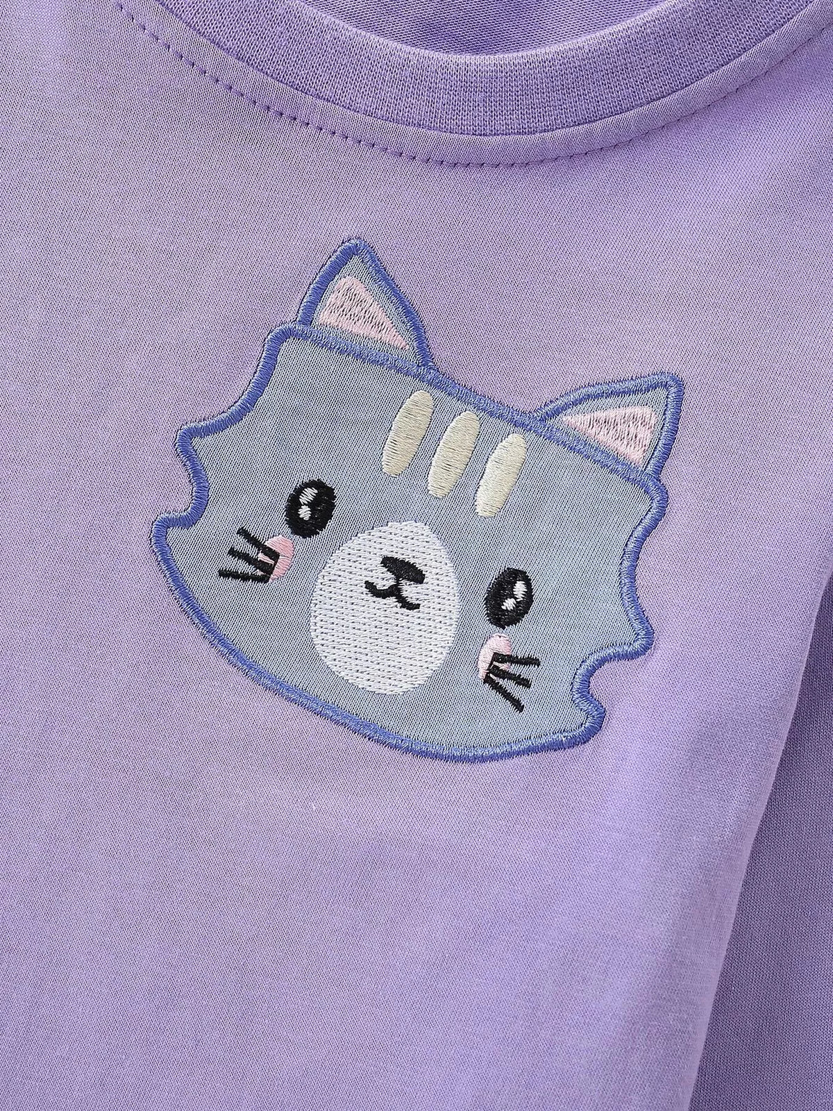 Blue and gray cat-face graphic on the purple sweatshirt