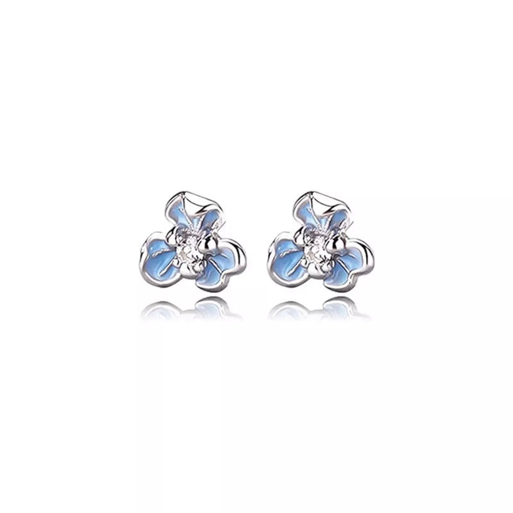 Silver-tone flower stud earrings with blue stones — detail view