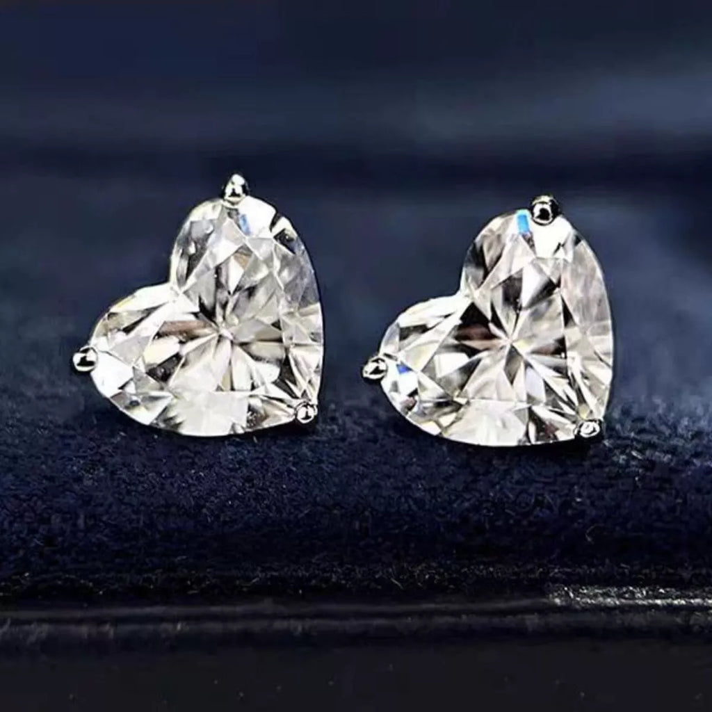 Silver-tone heart-shaped clear stone stud earrings — detail view