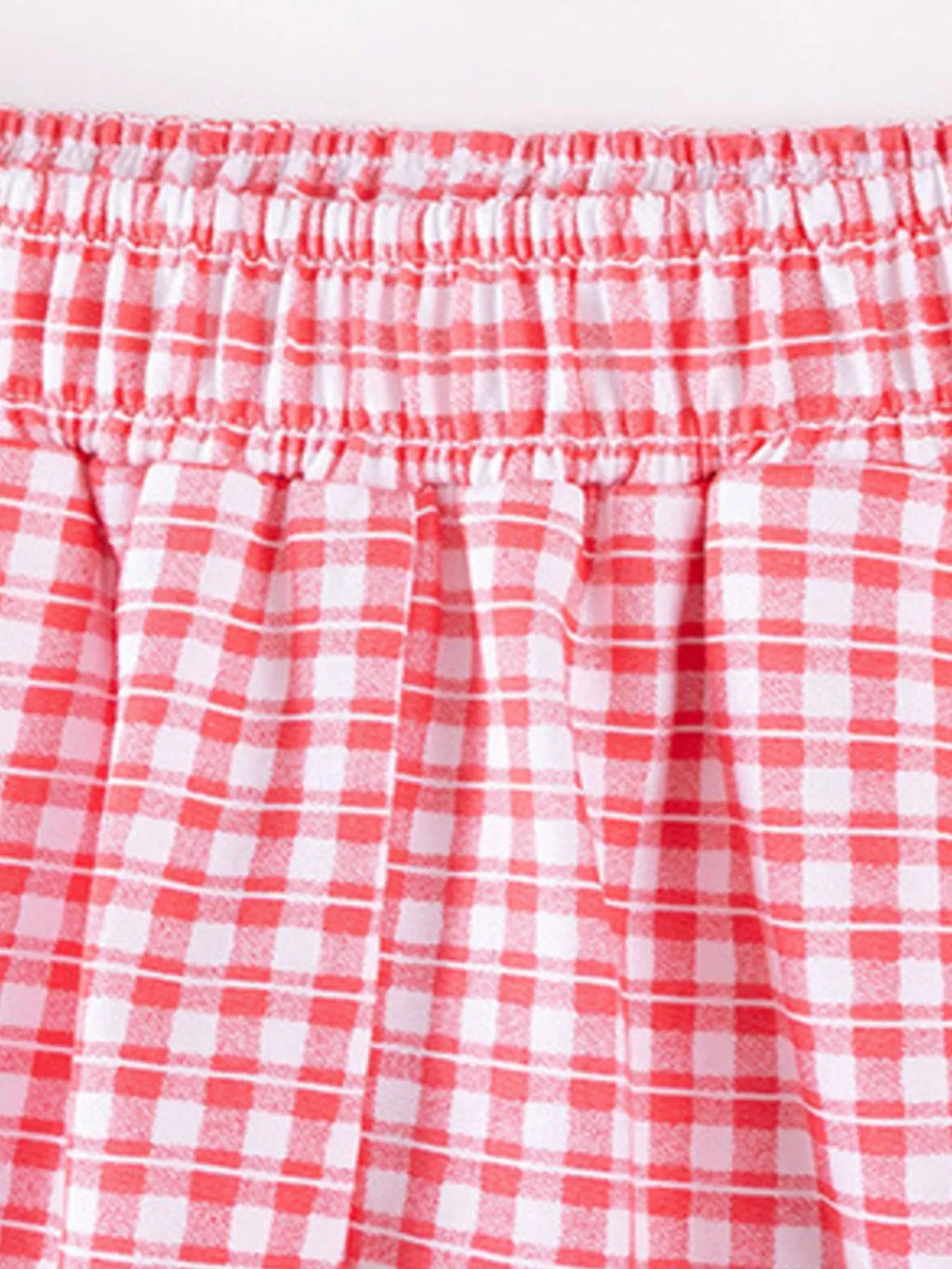 Close-up of the pink gingham pants' elastic waistband.