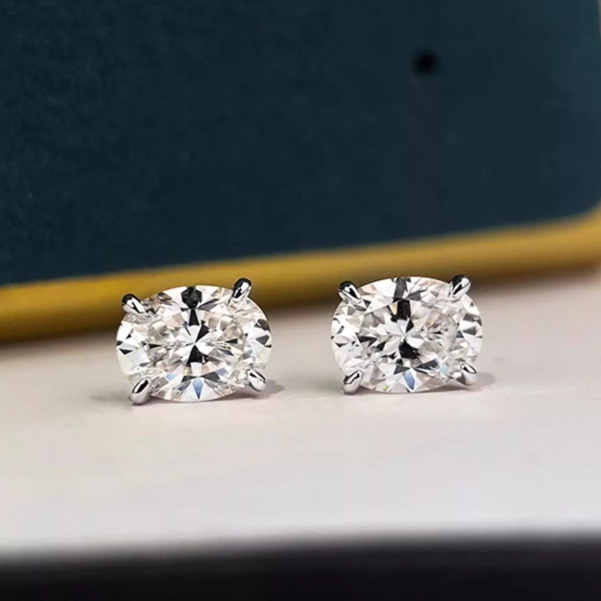 Silver-tone stud earrings with clear faceted stones — detail view