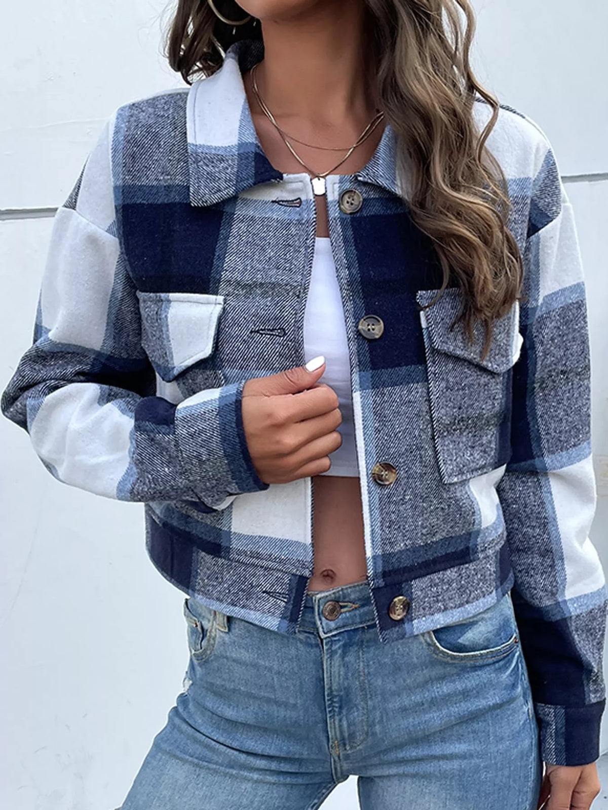 Navy color-block plaid cropped jacket with flap chest pockets, front view.