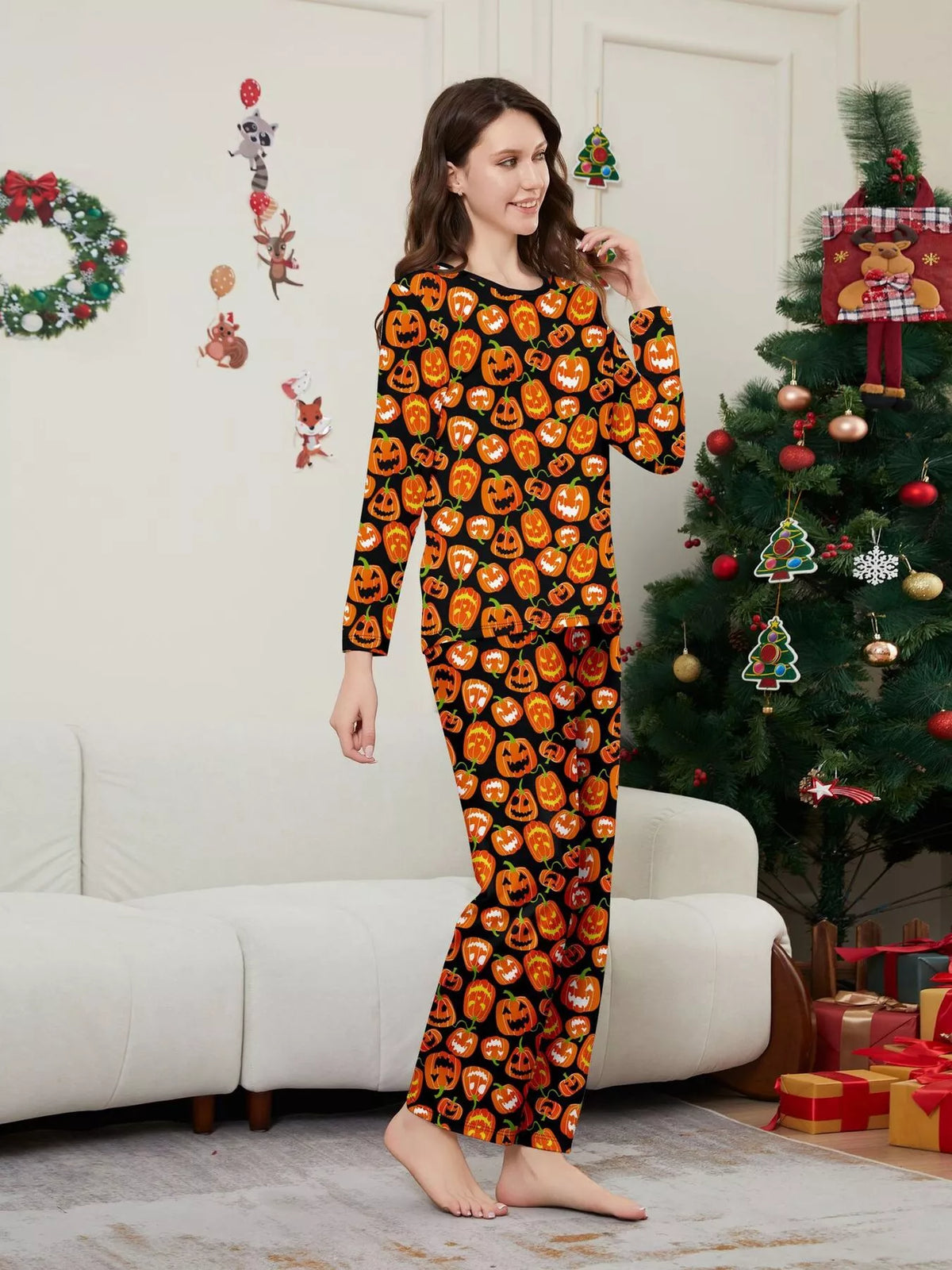 Angled view of the women's orange pumpkin-print pajama set.