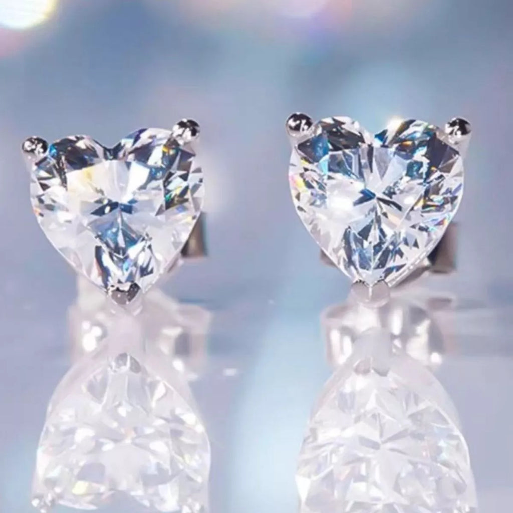 Silver-tone heart-shaped clear stone stud earrings — detail view