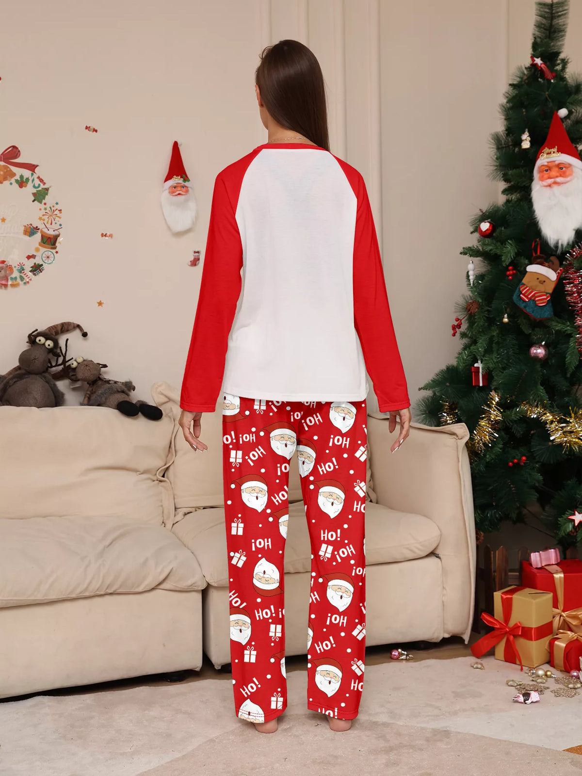 Back view of the white top with red sleeves and red Santa-print pants.