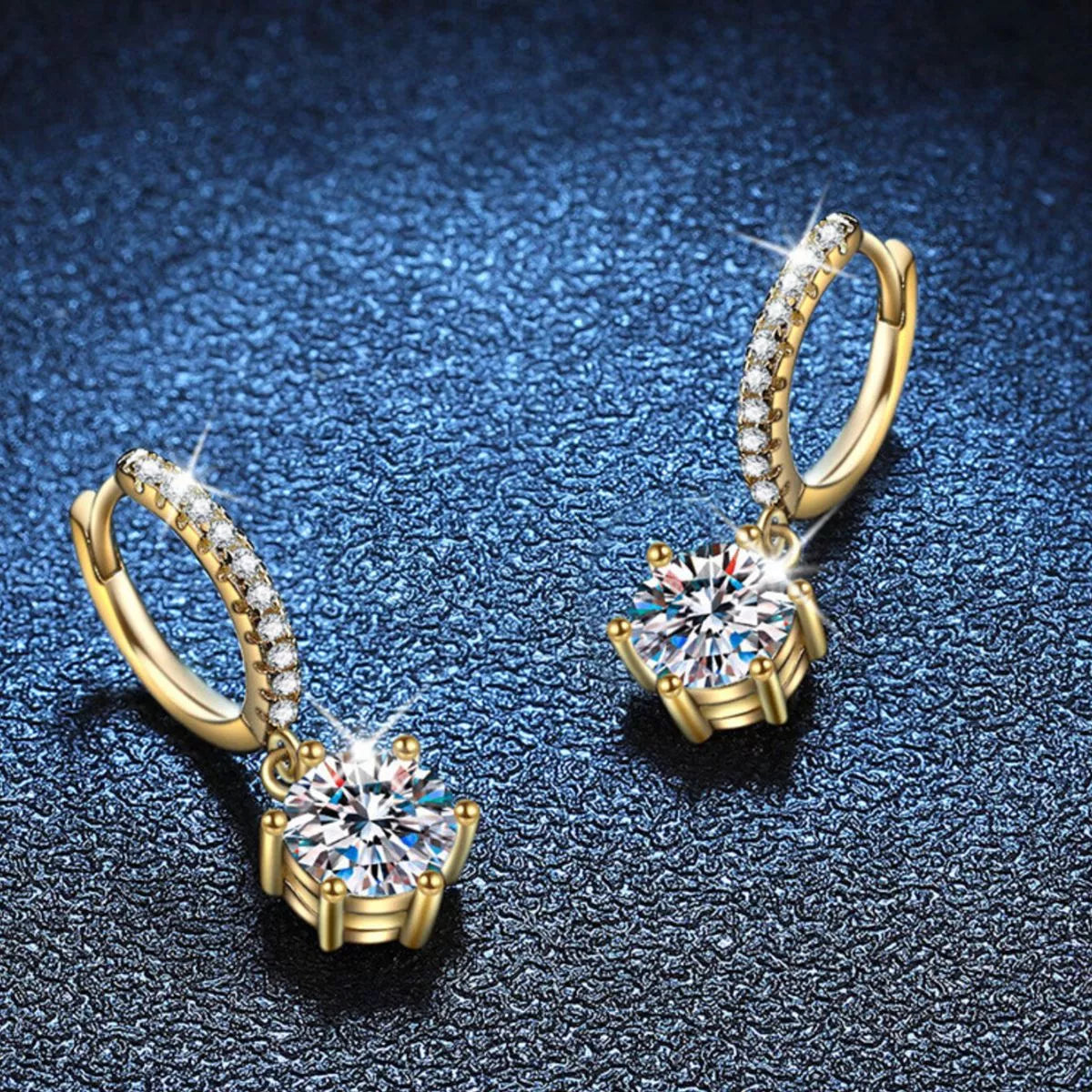 Gold-tone hoop earrings with round clear stone drops — detail view