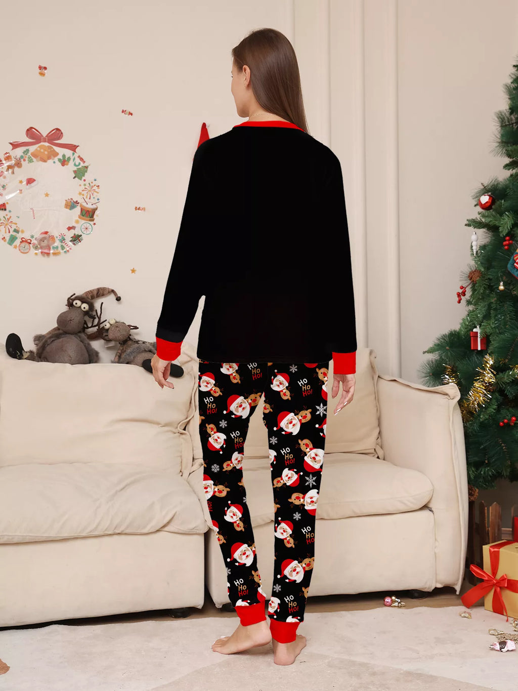 Back view of the women's black top and Santa-print pajama pants.