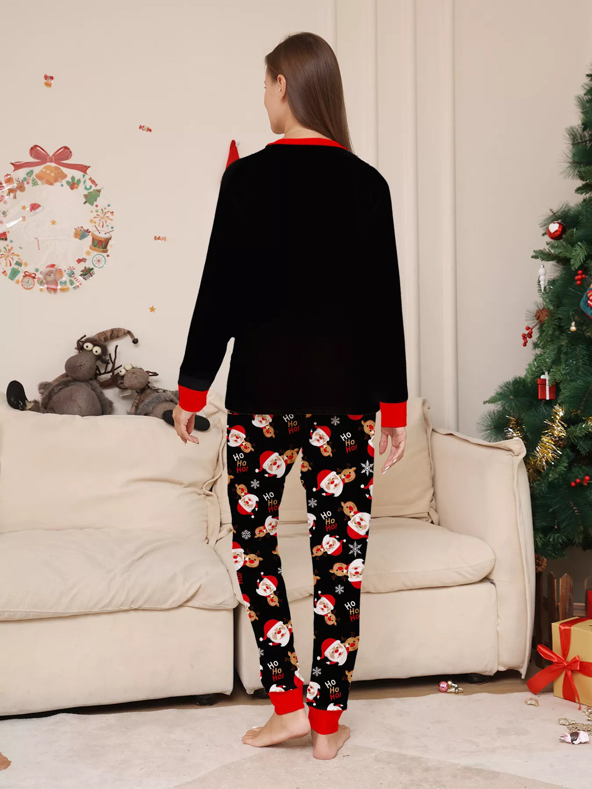 Back view of the women's black top and Santa-print pajama pants.