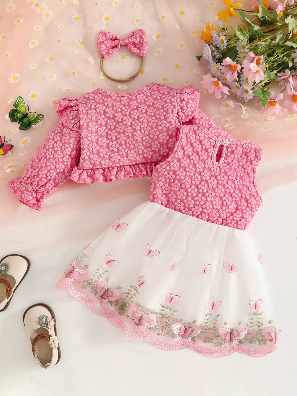 Back flat lay of the pink floral jacket, vest, white skirt and matching headband.