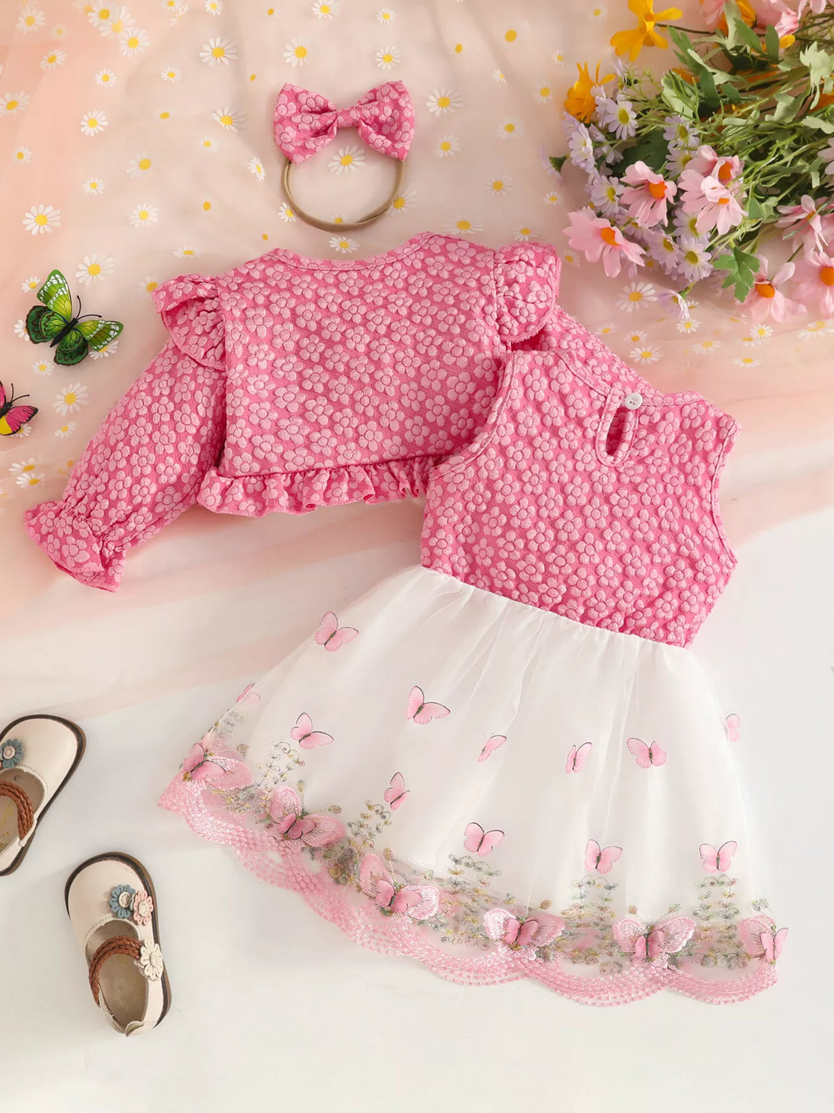 Back flat lay of the pink floral jacket, vest, white skirt and matching headband.