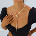 Gold-tone heart pendant lariat necklace with long chain tassels
