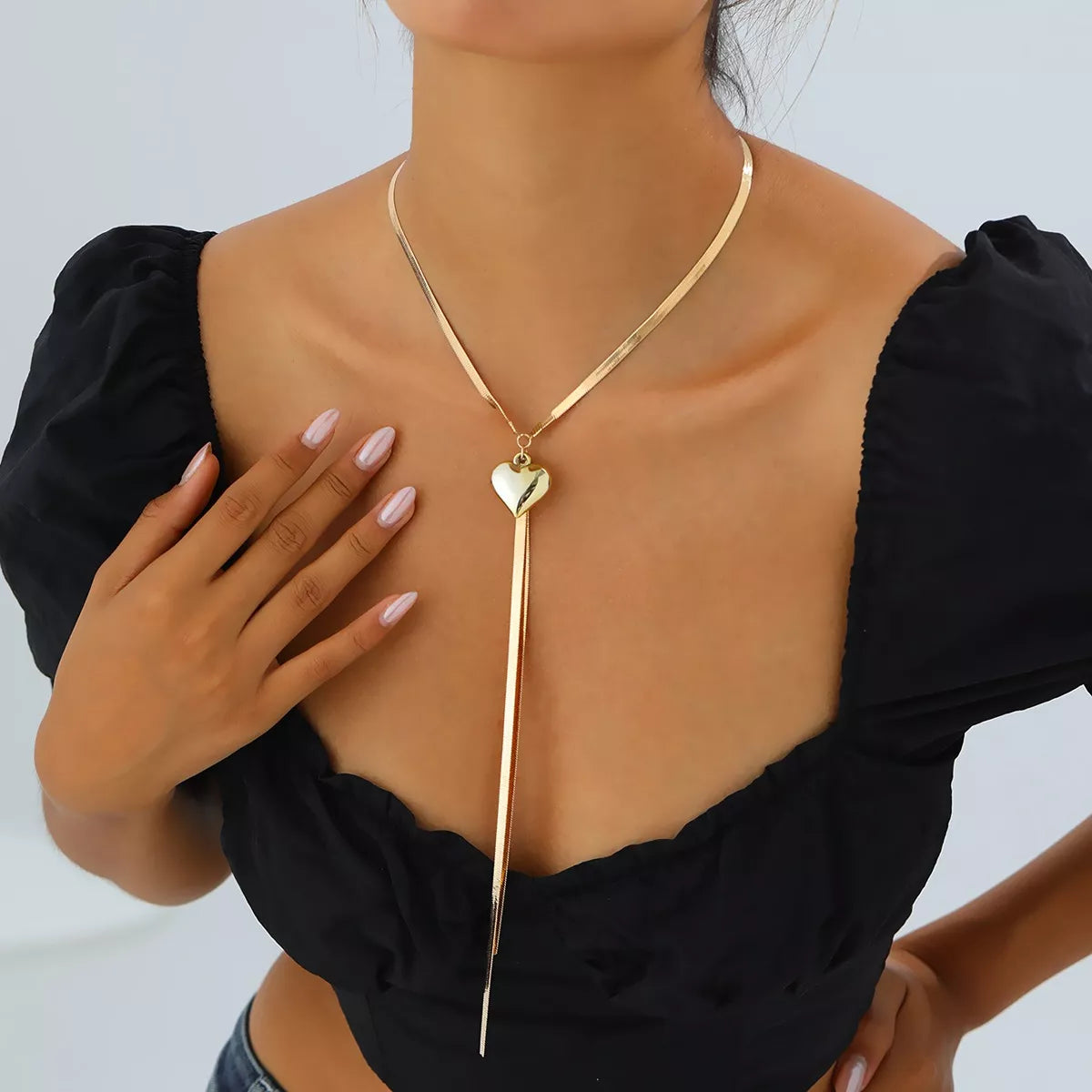 Gold-tone heart pendant lariat necklace with long chain tassels