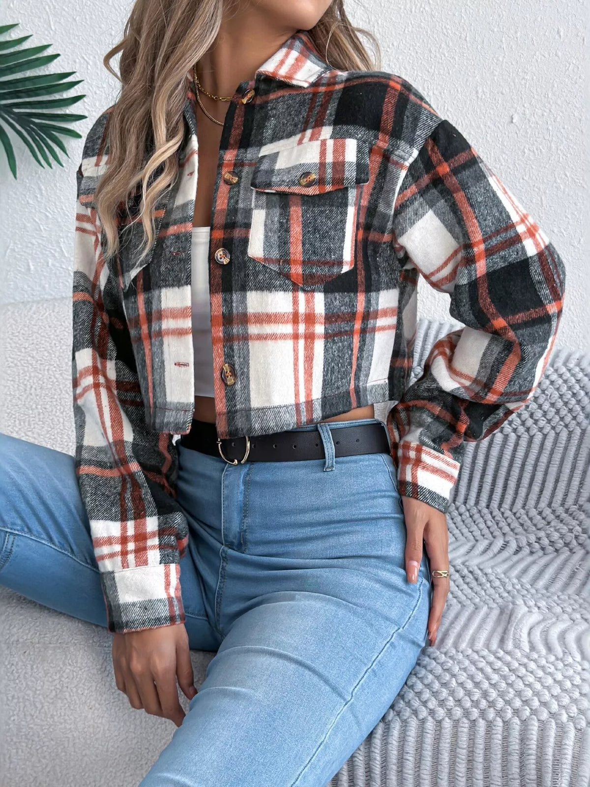 Angled front view of the black plaid cropped jacket.