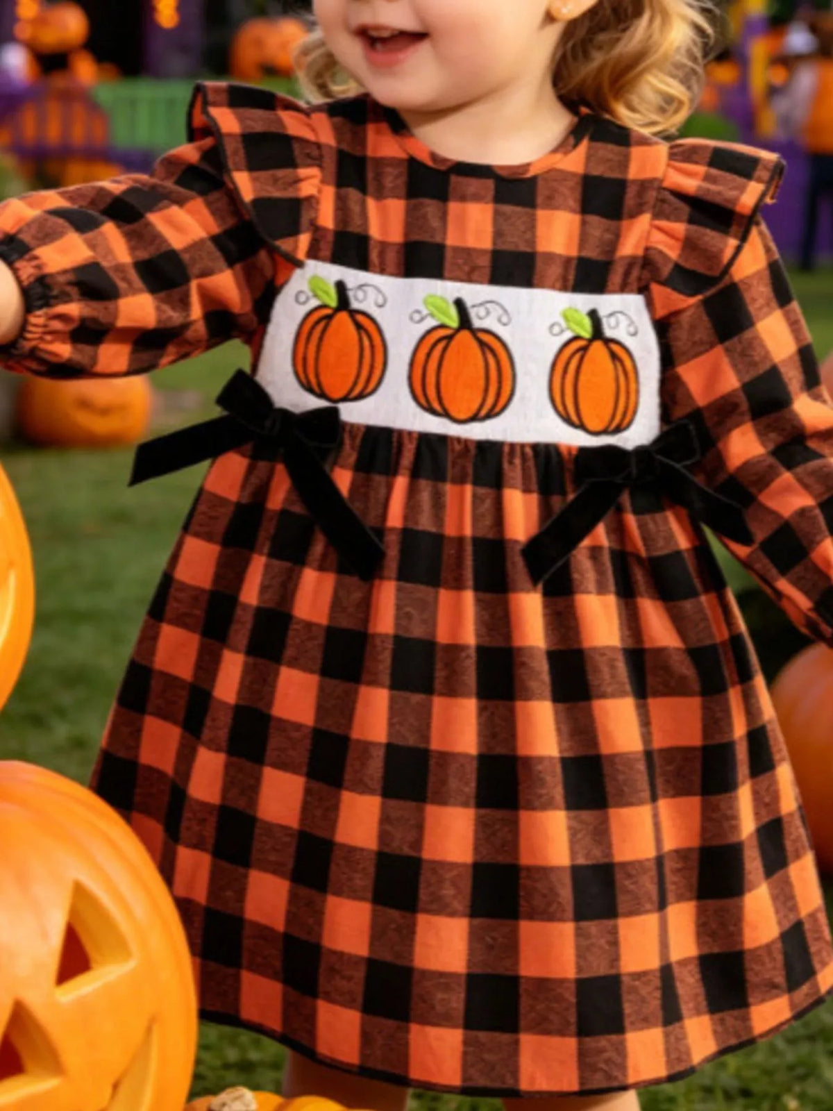 Pumpkin embroidery and smocked bodice on the orange and black plaid dress