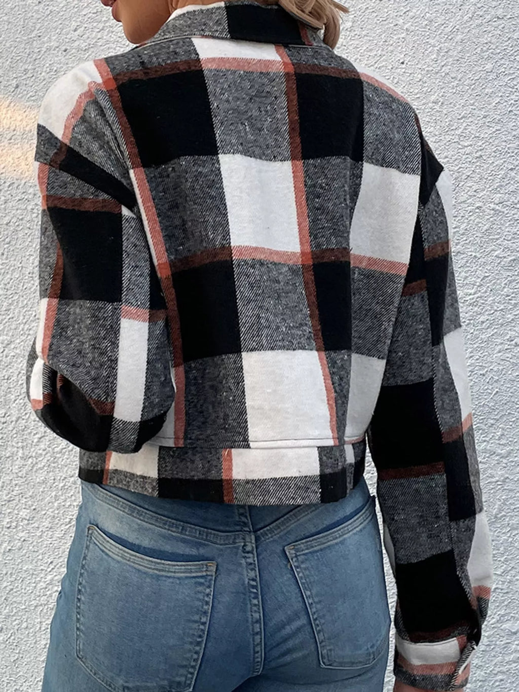 Black color-block plaid cropped jacket with flap chest pockets, back view.