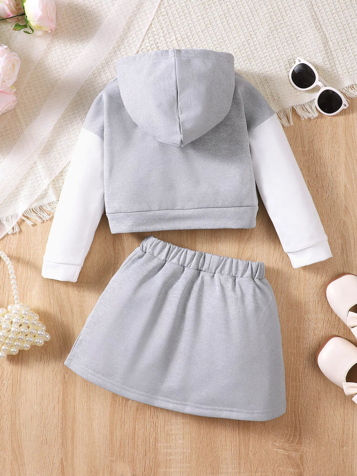 Children’s gray and white AESTHETICS graphic hoodie and gray skirt — back view