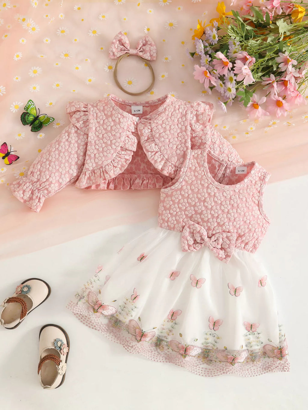Back flat lay of the blush floral jacket, vest, white skirt and matching bow headband.