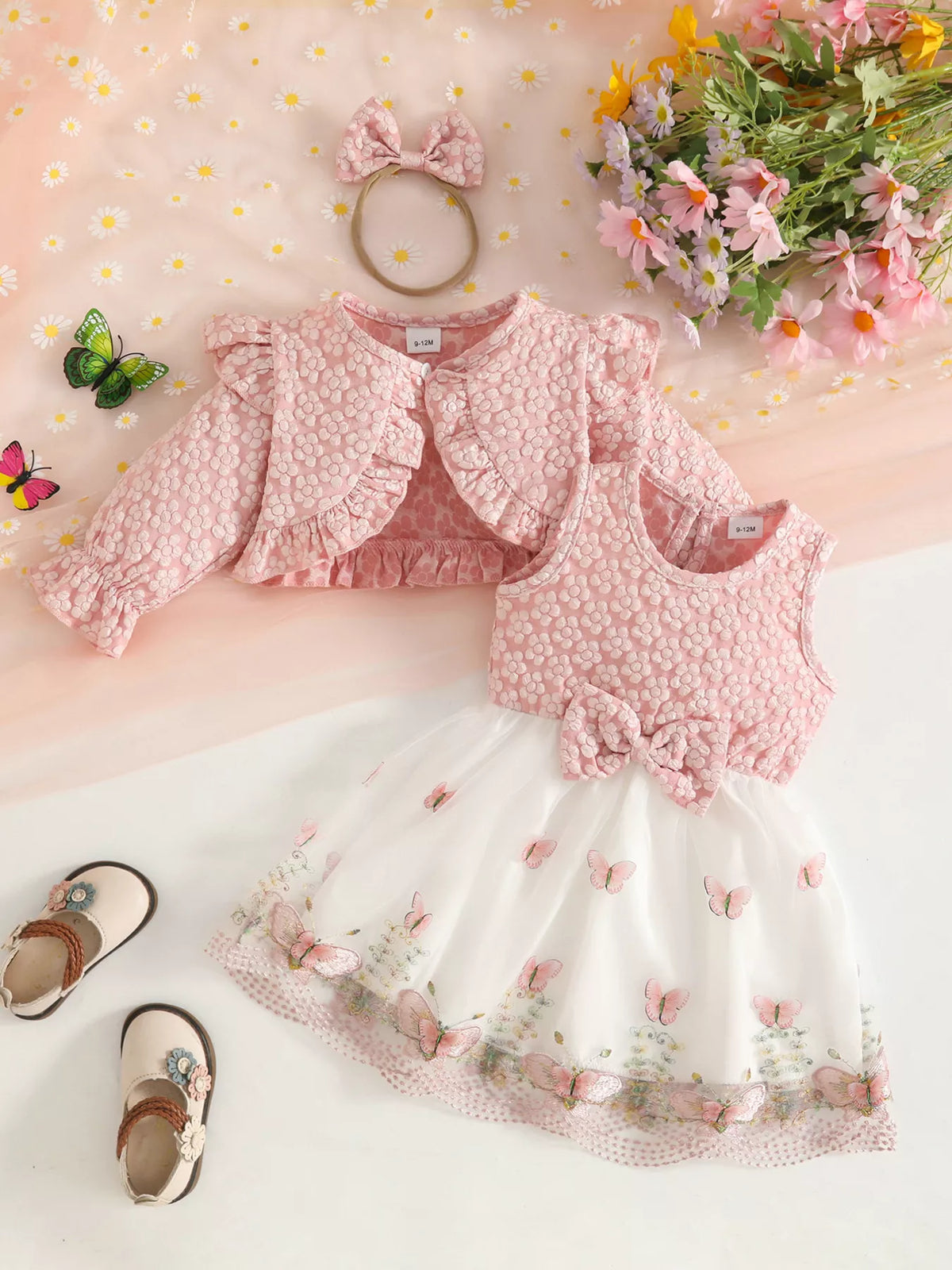 Back flat lay of the blush floral jacket, vest, white skirt and matching bow headband.
