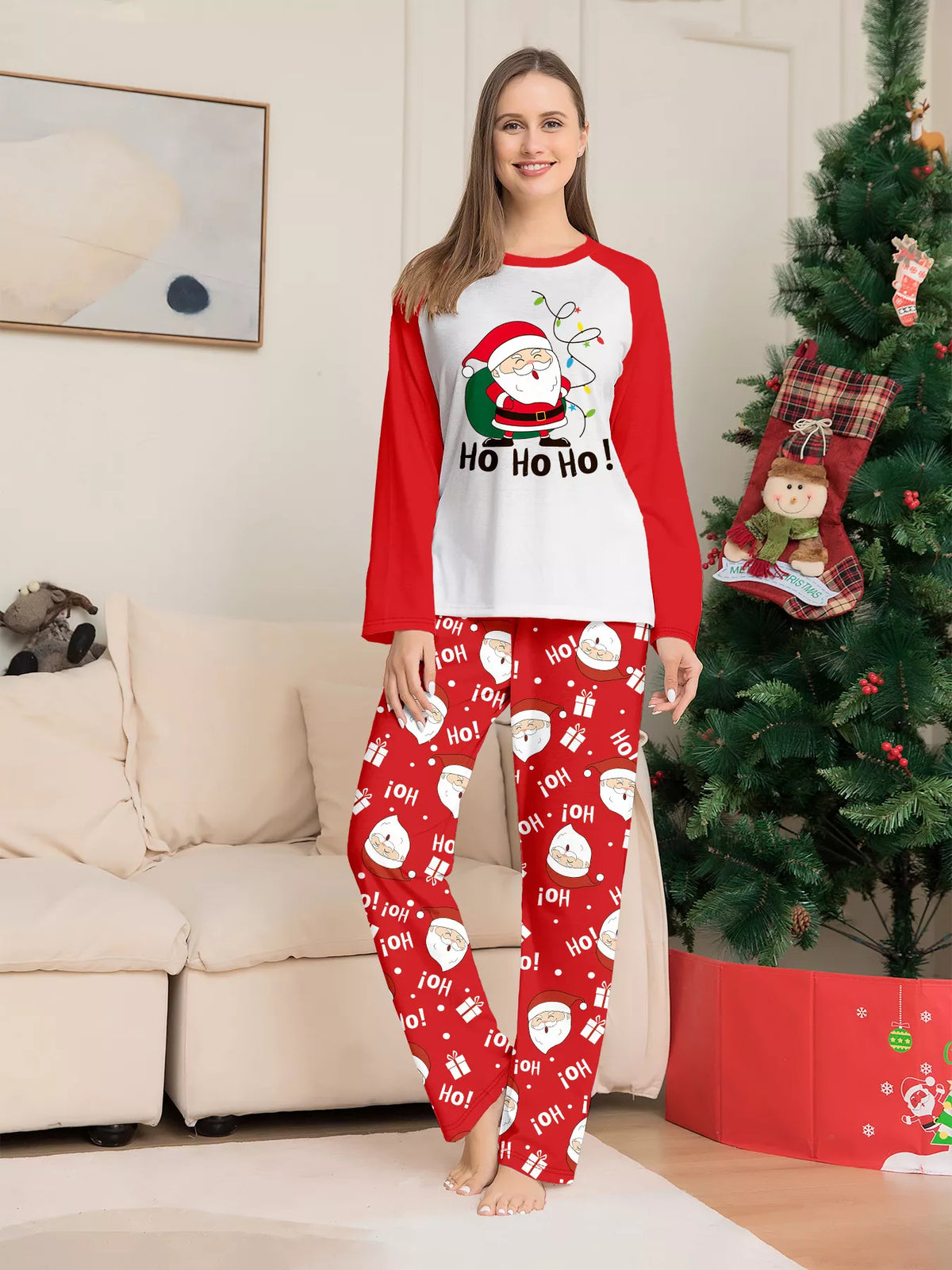 Front view of the women's white Santa top and red printed pajama pants.