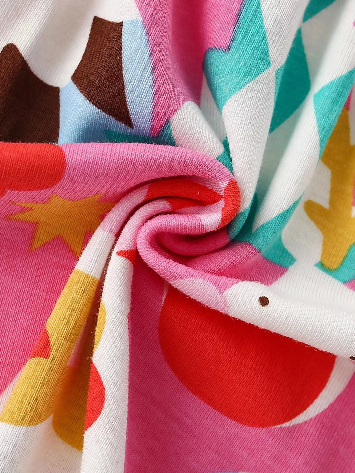Pink fabric with colorful Christmas ornament and tree patterns