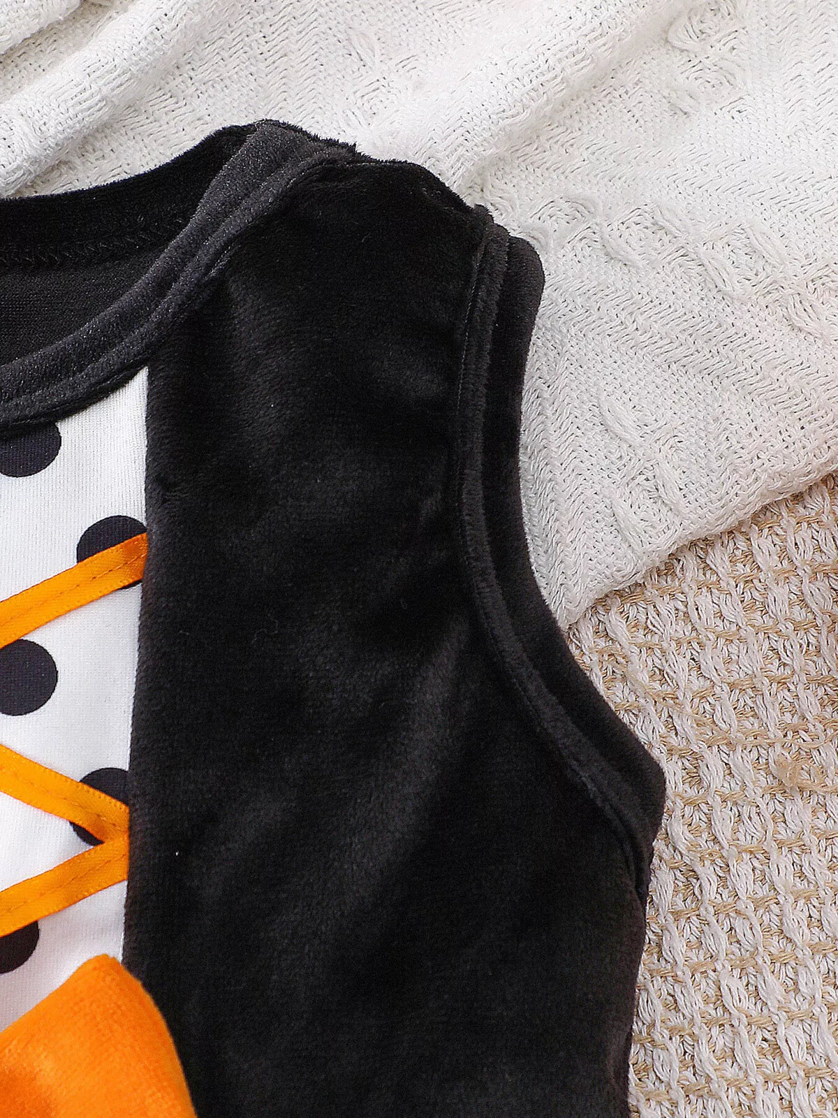 Close-up of the Halloween dress's black sleeveless armhole and bodice.