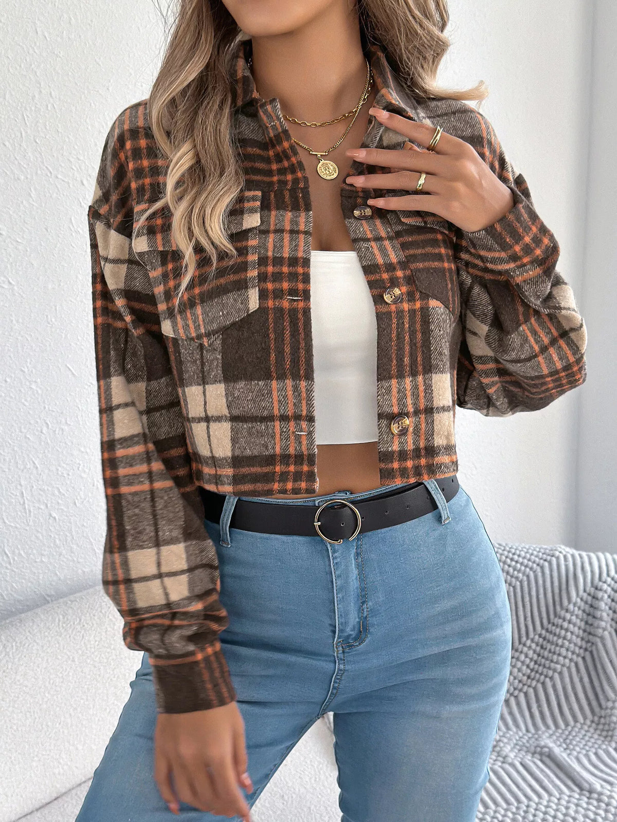 Brown plaid cropped button-up jacket modeled over a white top.