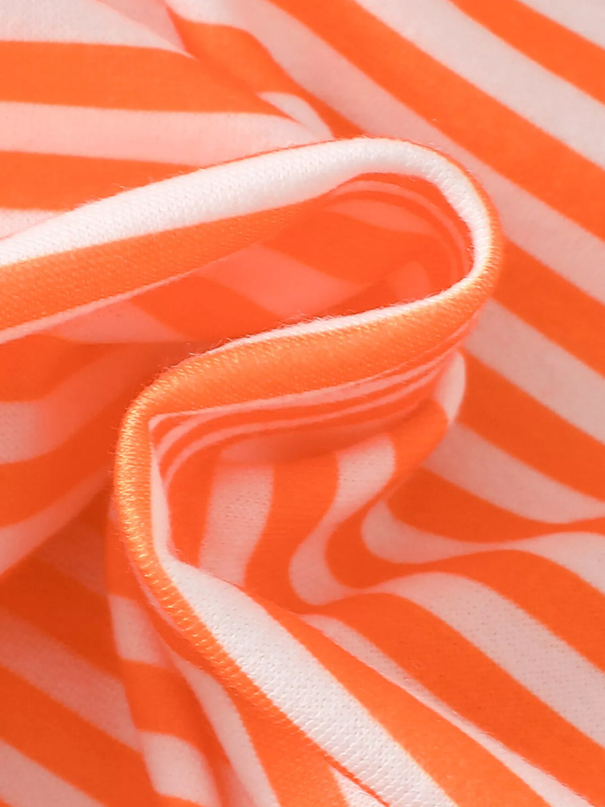 Folded orange-and-white striped fabric showing the top's texture.