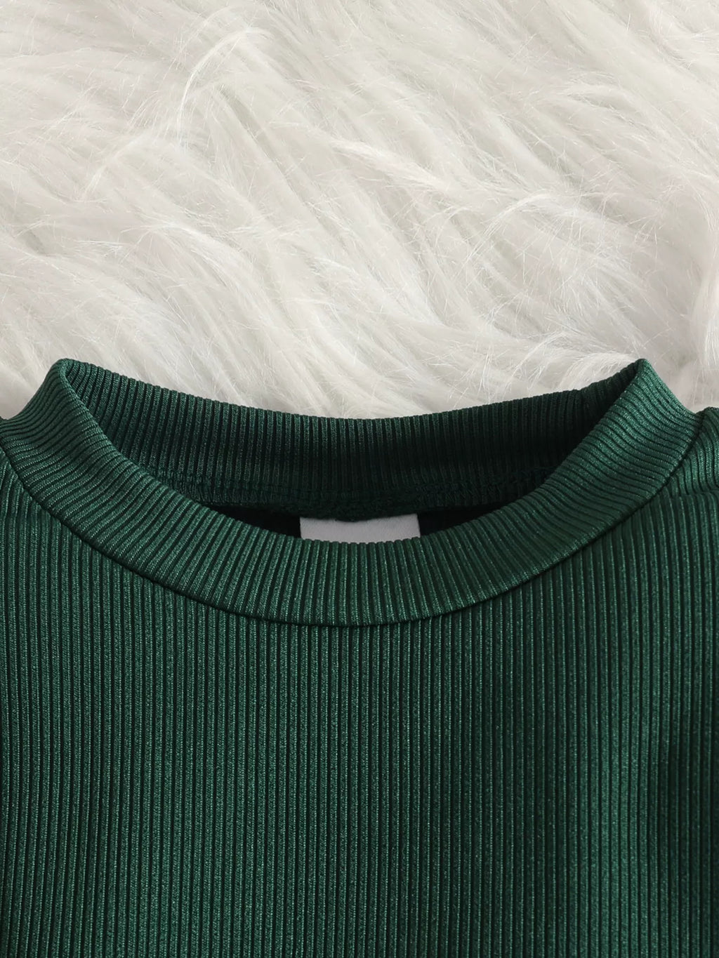 Close-up of the green top's ribbed neckline.