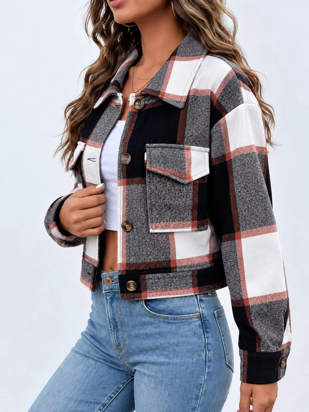 Black color-block plaid cropped jacket with flap chest pockets, side view.