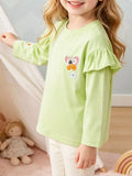 Child wearing a light green long-sleeve ruffle-shoulder top with butterfly and flower embroidery.