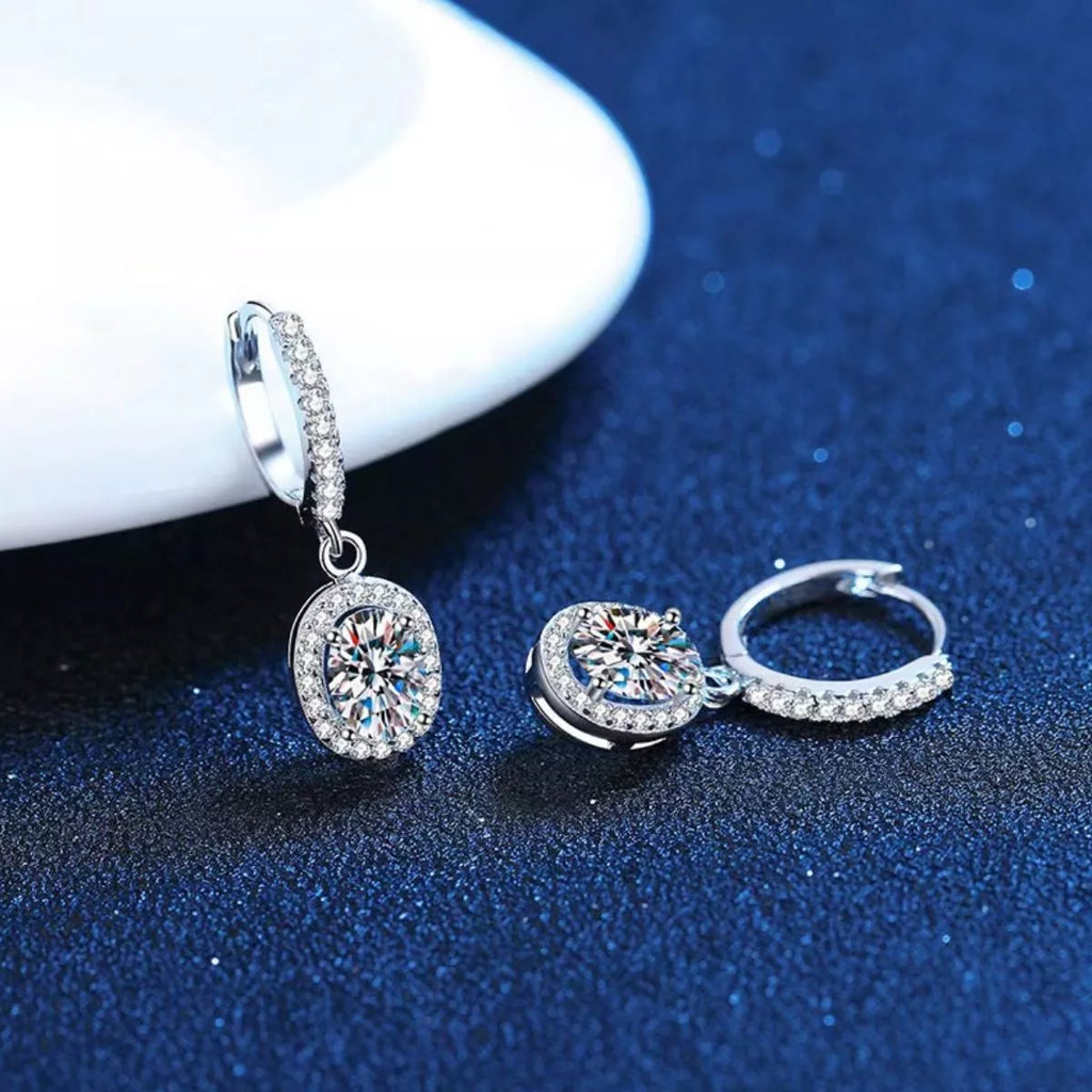 Silver-tone hoop earrings with oval halo stone drops — detail view
