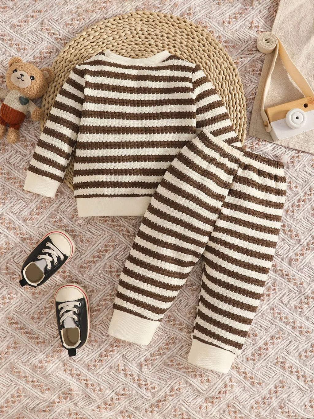 Brown and cream striped knit top and matching pants displayed flat