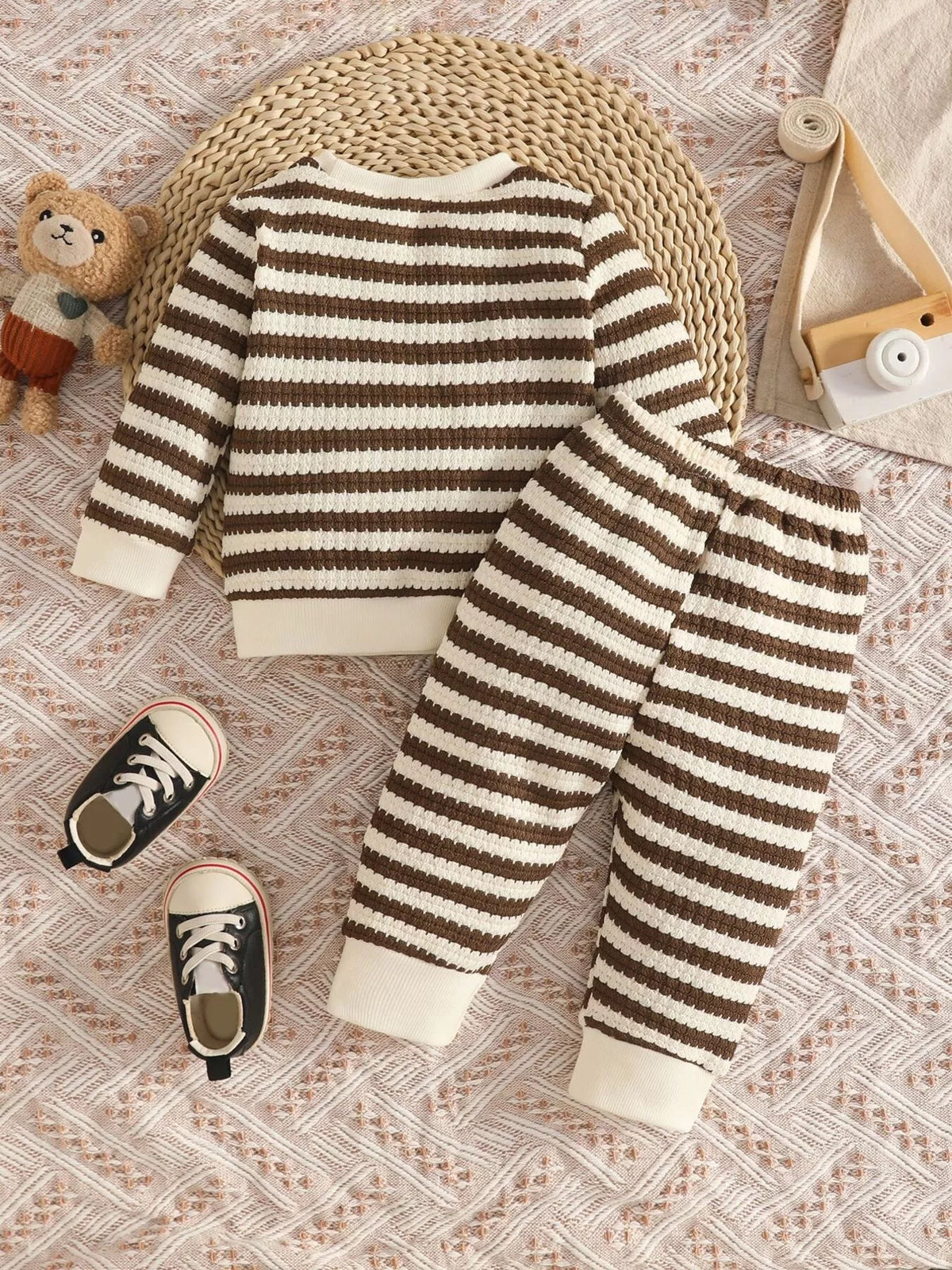 Brown and cream striped knit top and matching pants displayed flat