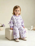 Purple floral-print long-sleeve lounge top and matching pants worn by a child