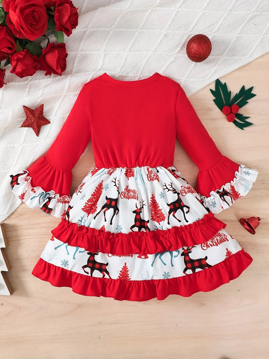 Back flat lay of the red Christmas dress with printed skirt panels and red ruffles.