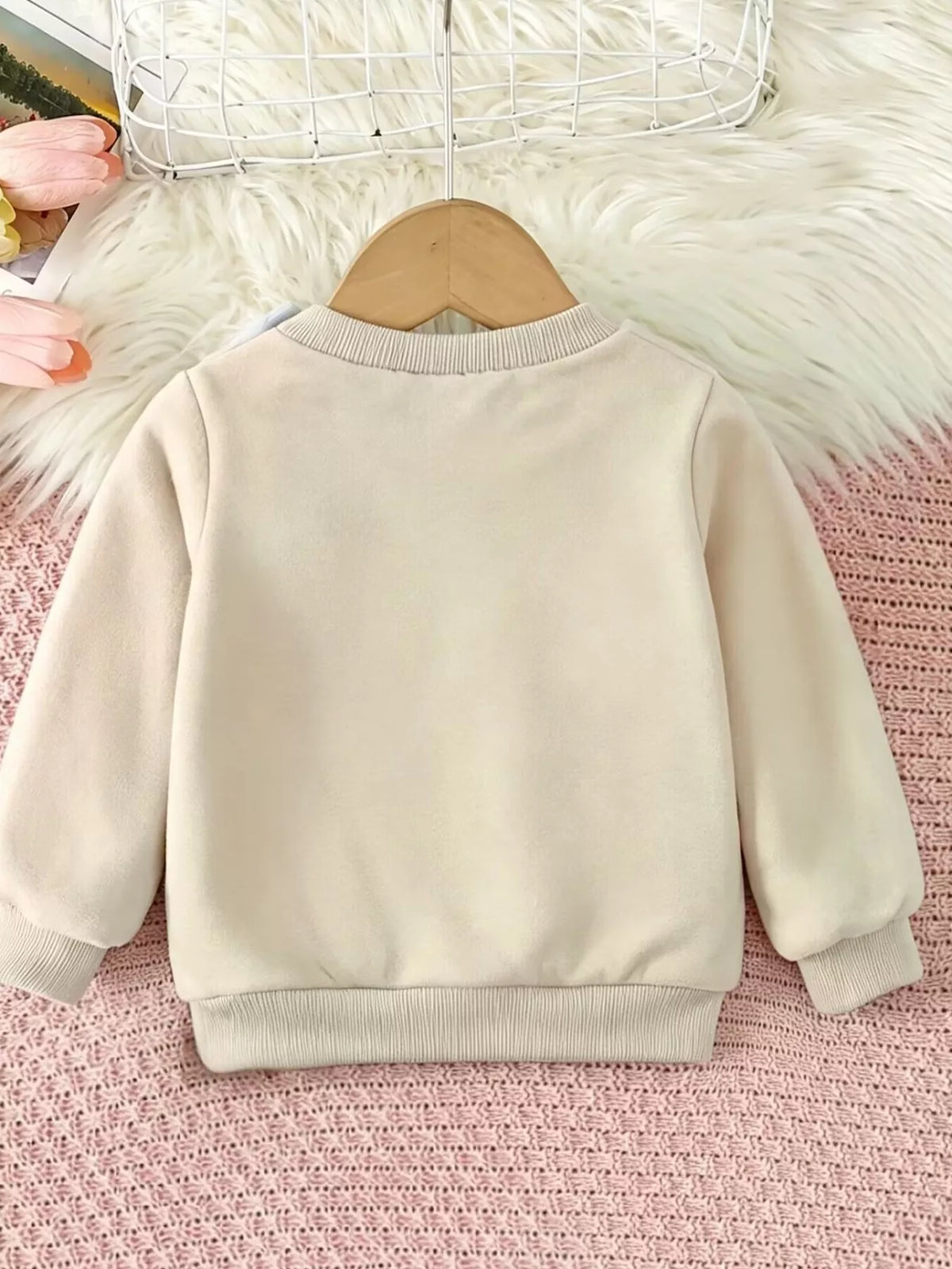 Back view of the plain cream children's sweatshirt.