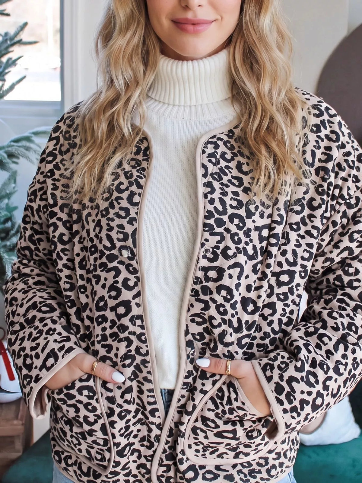 Leopard-print jacket worn open over a cream top.