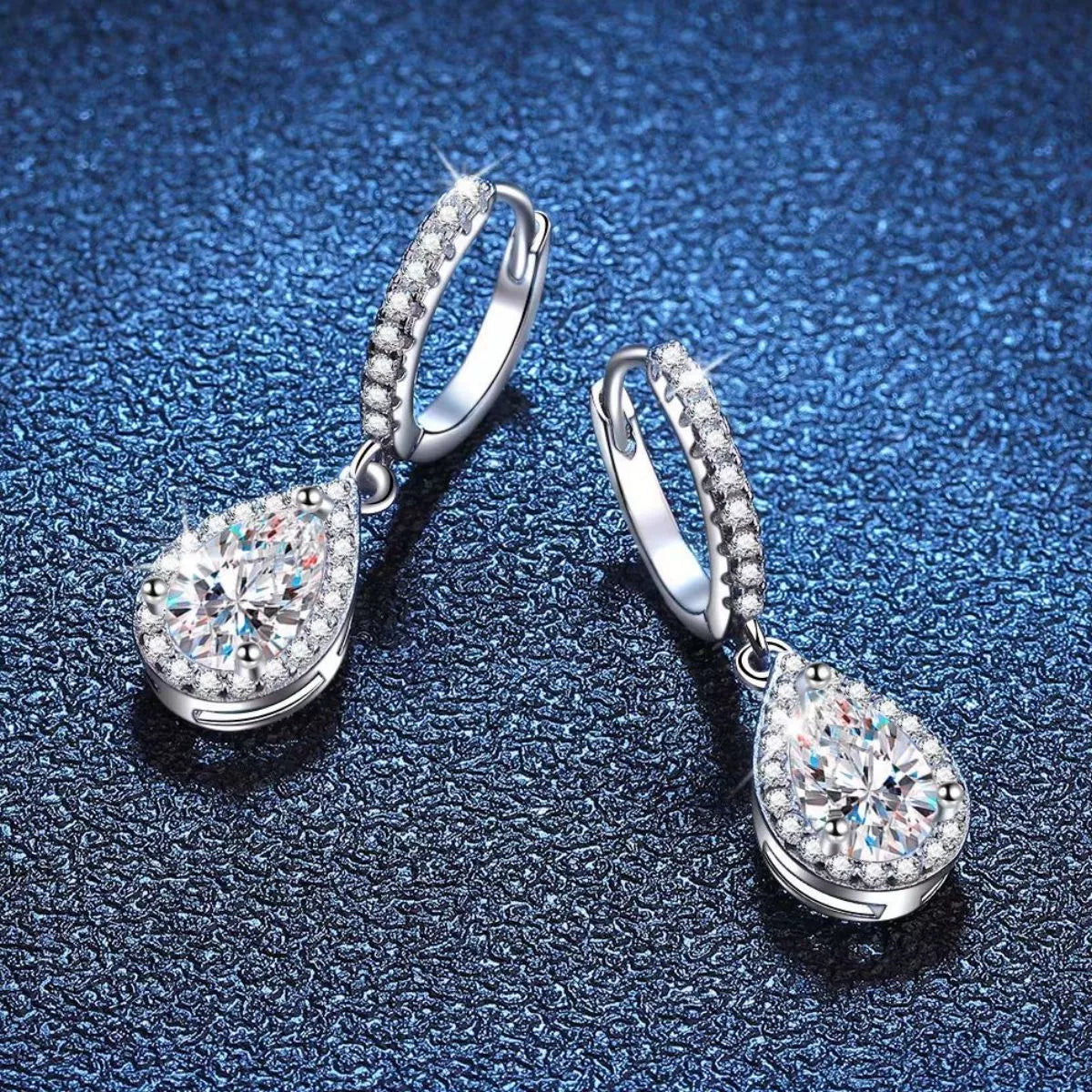 Silver-tone hoop earrings with teardrop halo stone drops