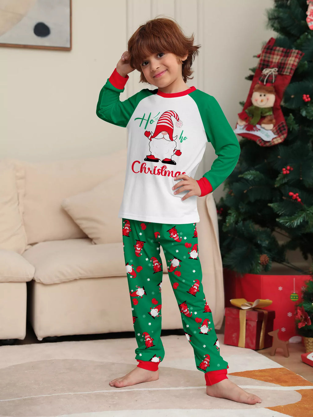 Child modeling the white and green Christmas graphic pajama set.
