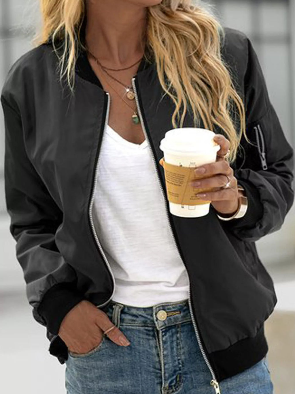 Black lightweight zip-up bomber jacket modeled over a white top.