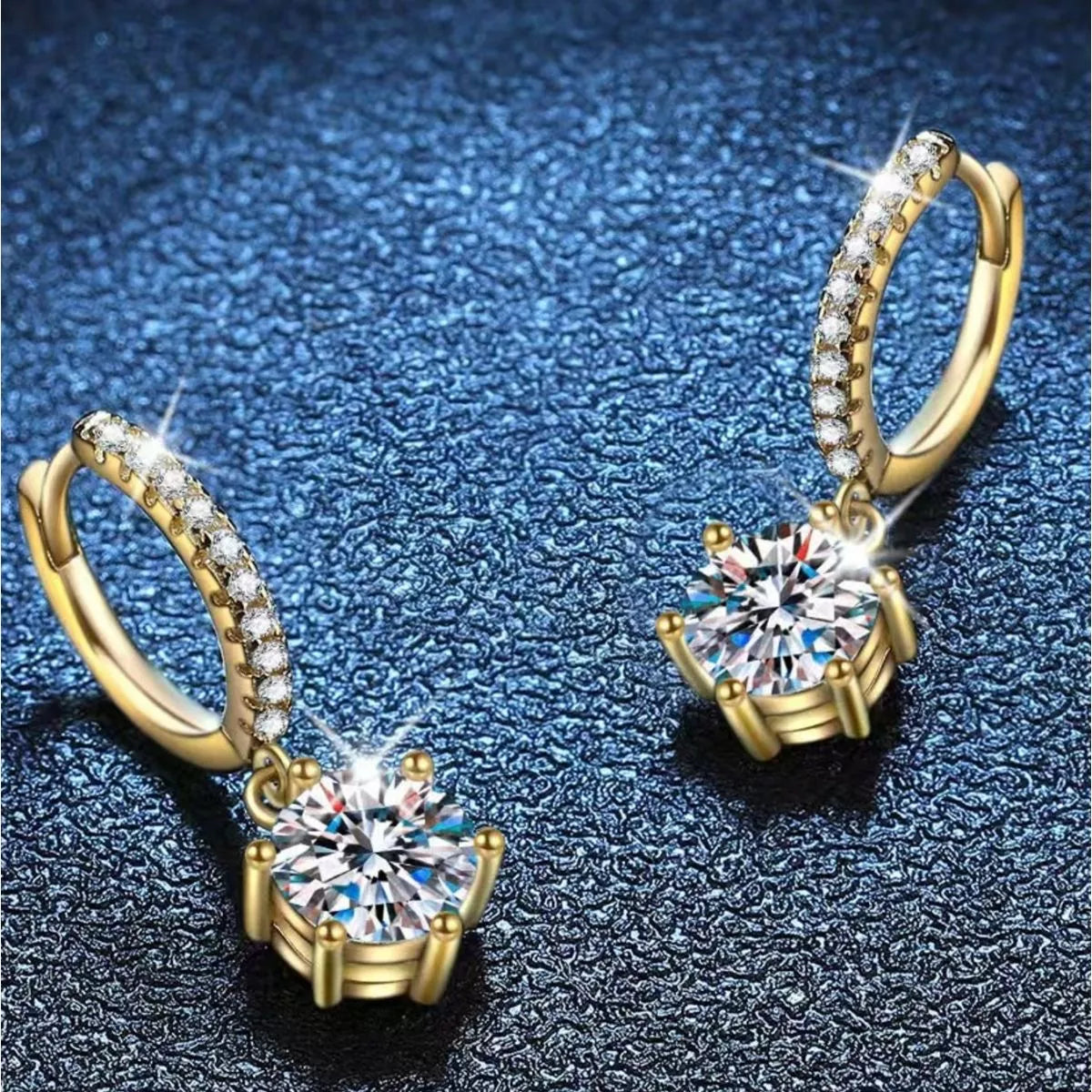 Gold-tone hoop earrings with round clear stone drops — detail view